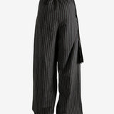 Black pants worn by a person, showing the pants' fit