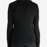 Black sweater worn by a person, showing the sweater's fit
