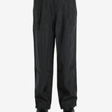 Black pant worn by a person, showing the pant’s fit