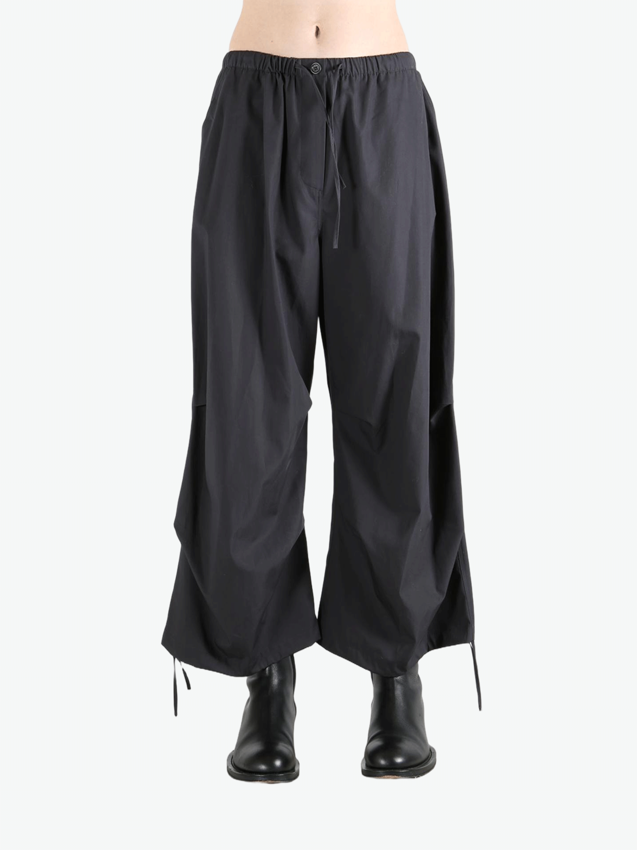 Black pants worn by a person, showing the pants' fit