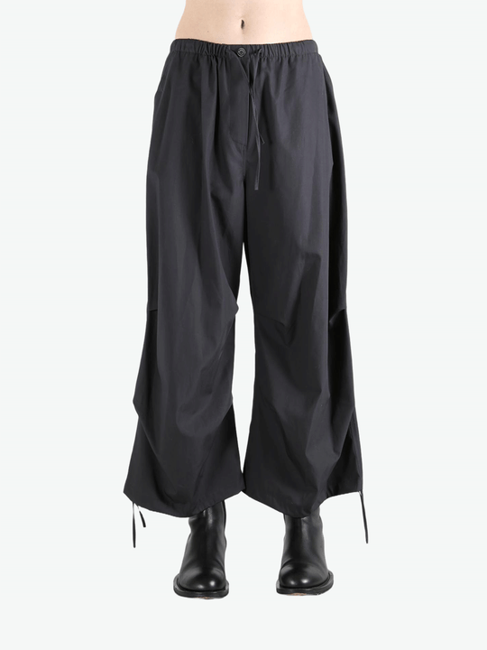 Black pants worn by a person, showing the pants' fit