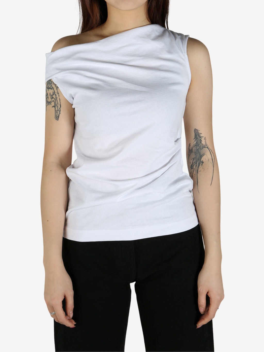 White top worn by a person, showing the top's fit