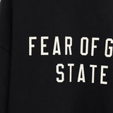 Close up of the black t-shirt, showing texture of the cotton fabric