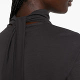Black top worn by a person, showing the top fit