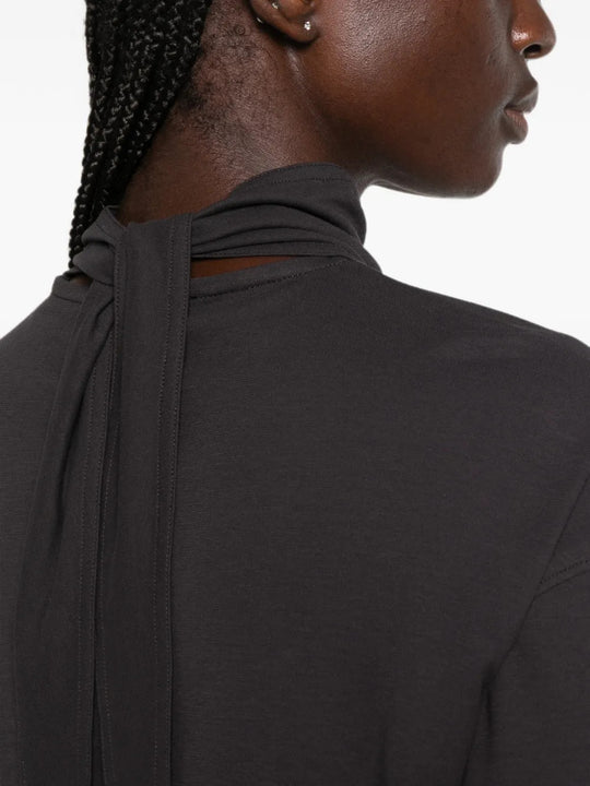 Black top worn by a person, showing the top fit