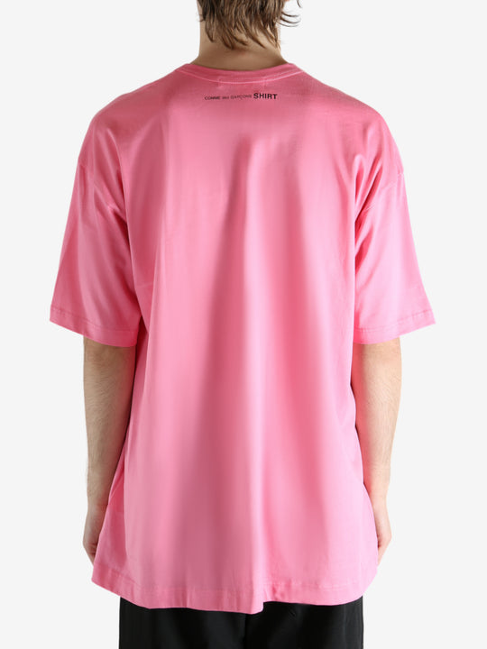 Pink t-shirt worn by a person, showing the shirt's fit
