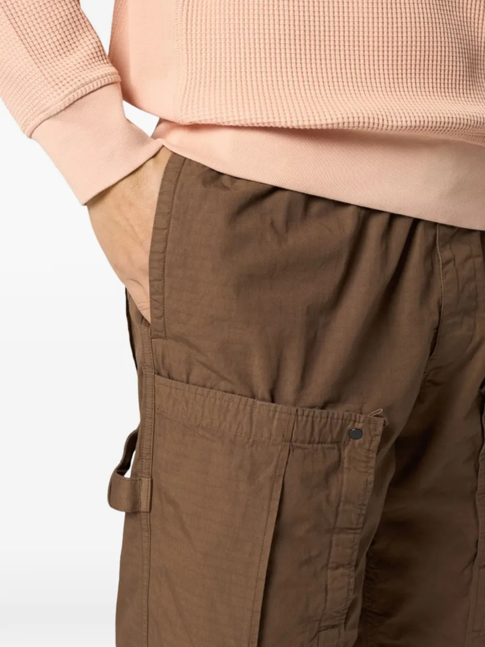 Close up of brown pants, showing texture of the cotton fabric
