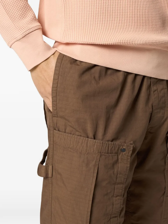 Close up of brown pants, showing texture of the cotton fabric