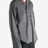 Grey shirt worn by a person. showing the shirt's fit