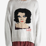 Grey sweater worn by a person, showing the sweater fit