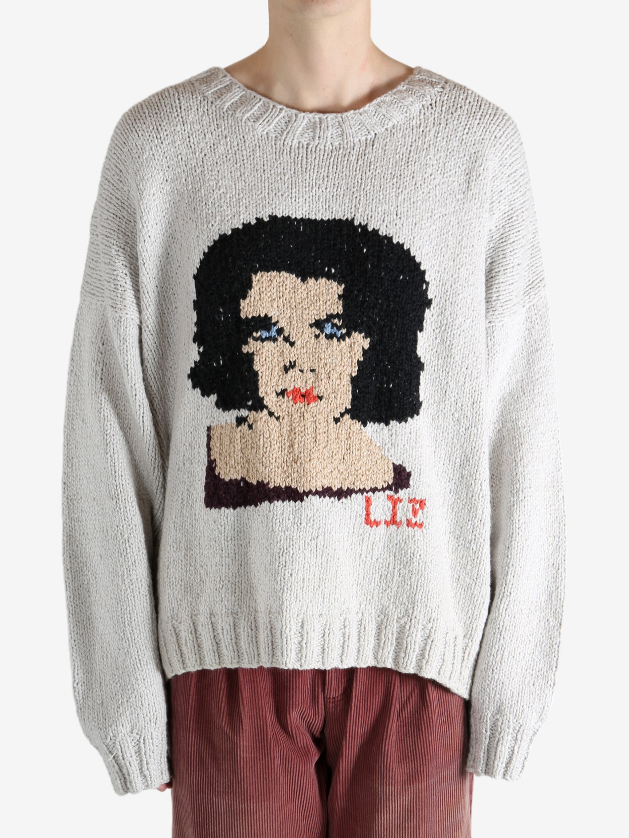 Grey sweater worn by a person, showing the sweater fit