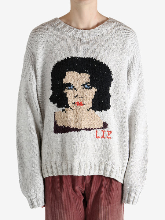 Grey sweater worn by a person, showing the sweater fit