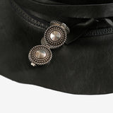 Close up of black hat, showing texture of the leather fabric