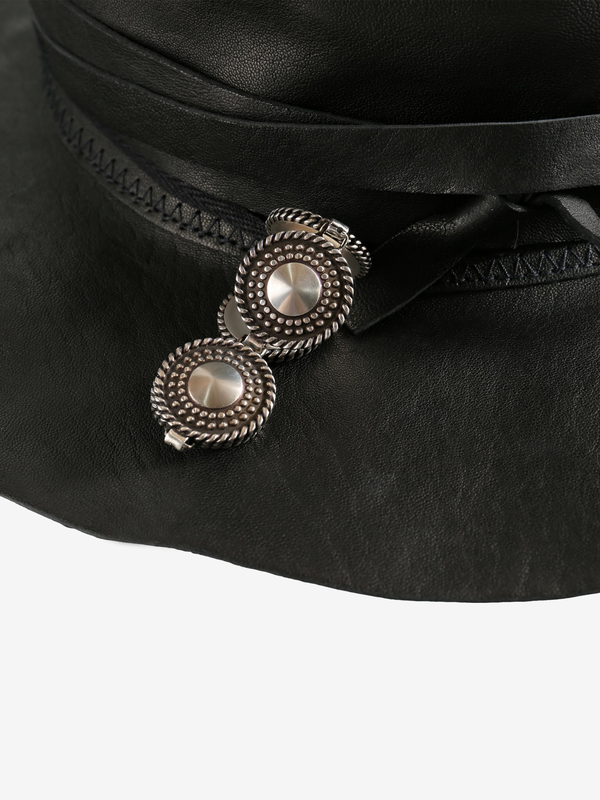 Close up of black hat, showing texture of the leather fabric
