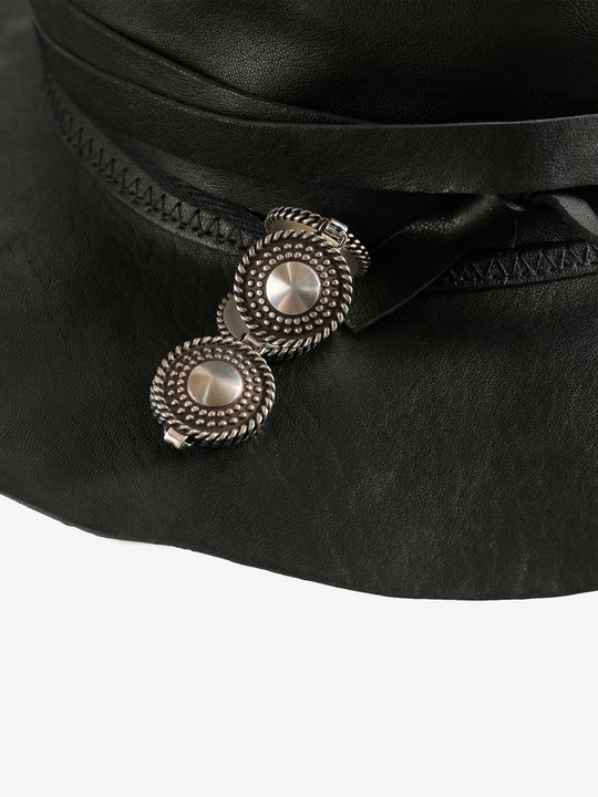 Close up of black hat, showing texture of the leather fabric