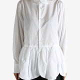 White shirt worn by a person, showing the shirt's fit