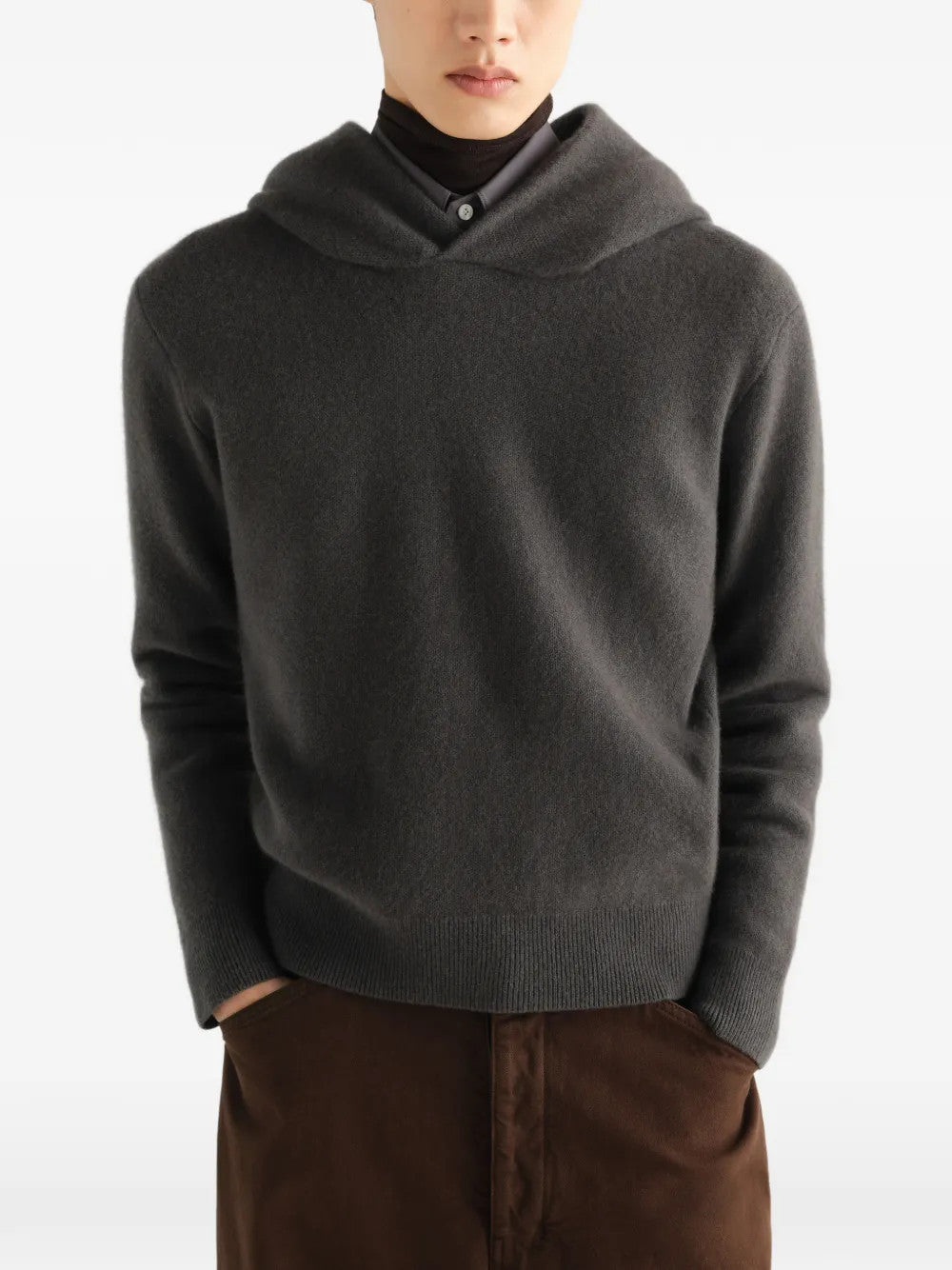 Grey knitwear worn by a person, showing the knitwear fit