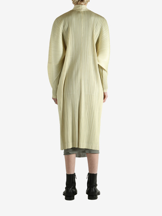 Yellow coat worn by a person, showing the coat's fit