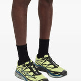 Yellow sneakers worn by a person, showing the sneakers's fit