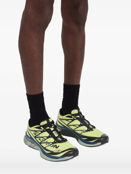 Yellow sneakers worn by a person, showing the sneakers's fit