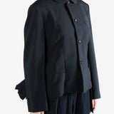 Black jacket worn by a person, showing the jacket fit