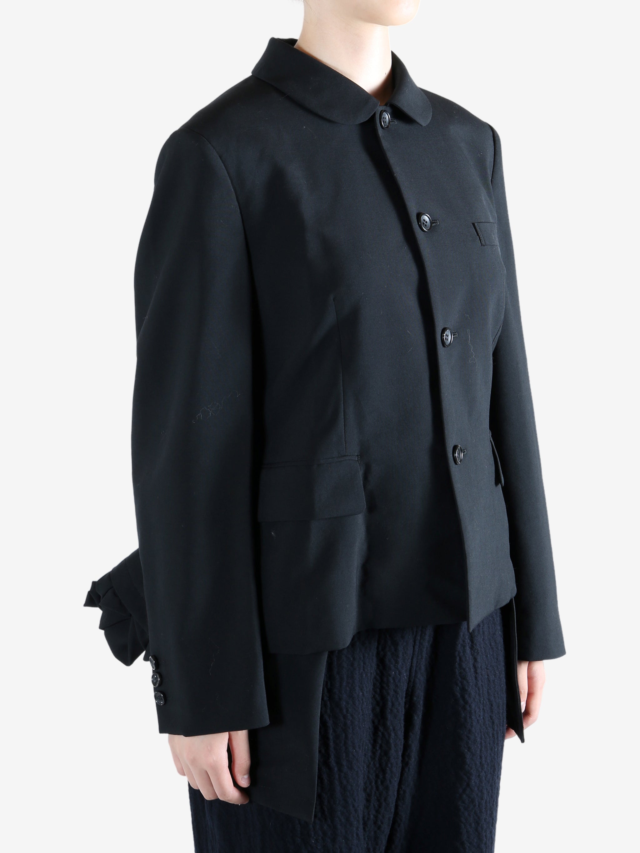 Black jacket worn by a person, showing the jacket fit