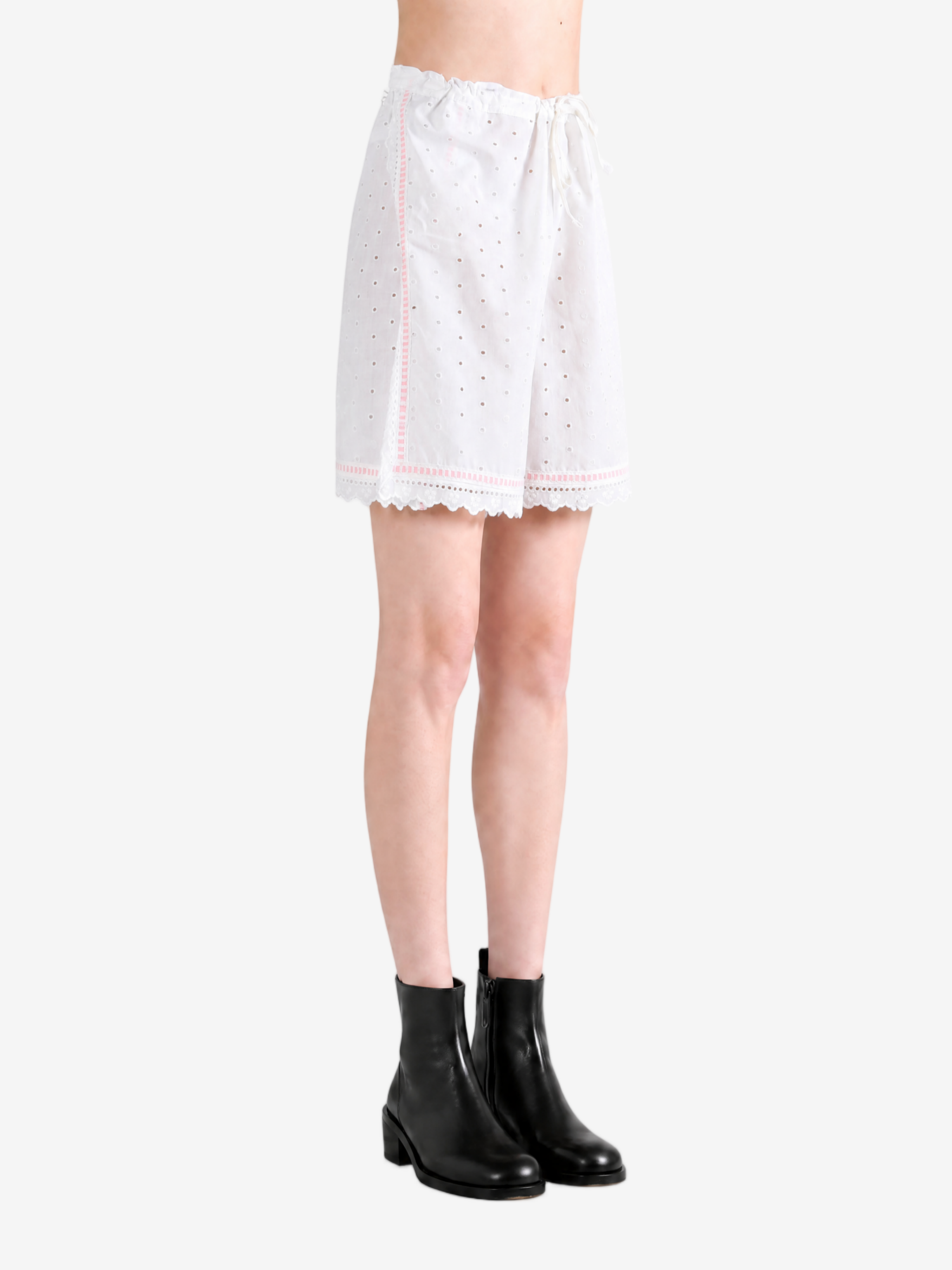 White shorts worn by a person, showing the shorts fit