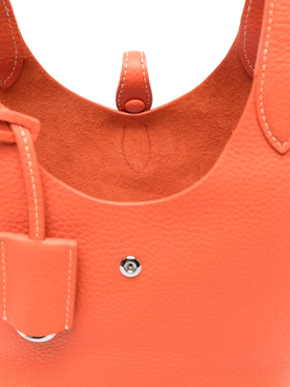 Close up of orange bag, showing texture of the calf leather fabric