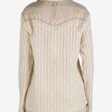 Tan shirt worn by a person, showing the shirt’s fit