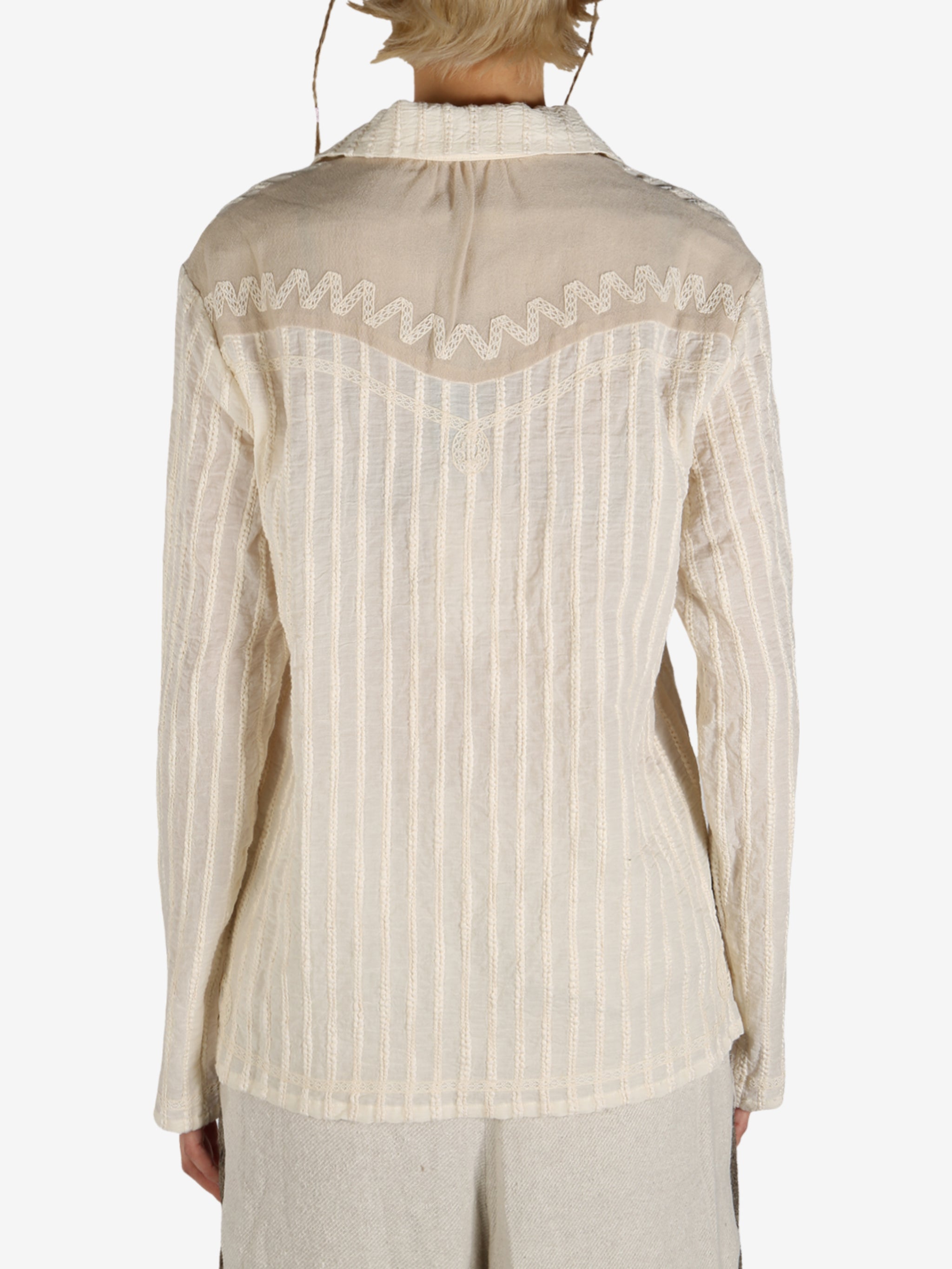 Tan shirt worn by a person, showing the shirt’s fit