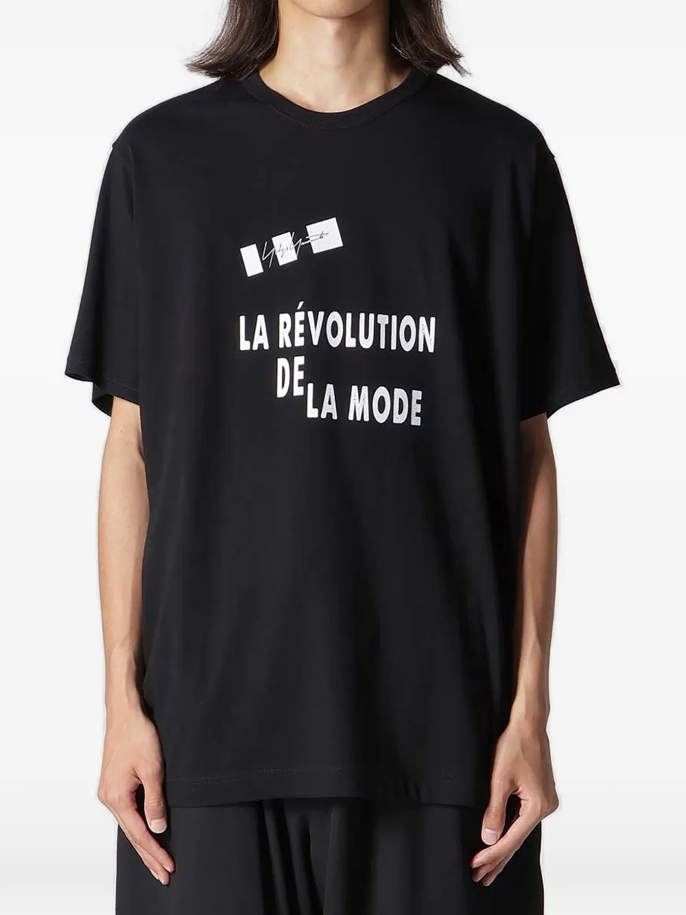 Black t-shirt worn by a person, showing the t-shirt fit