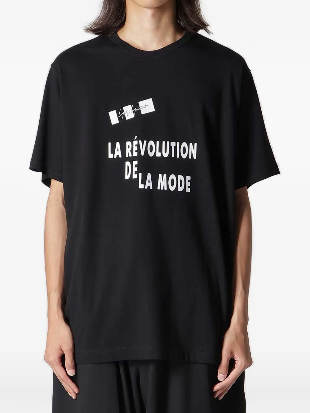 Black t-shirt worn by a person, showing the t-shirt fit