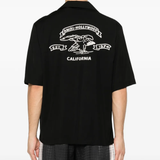 black shirt worn by a person, showing the shirt fit