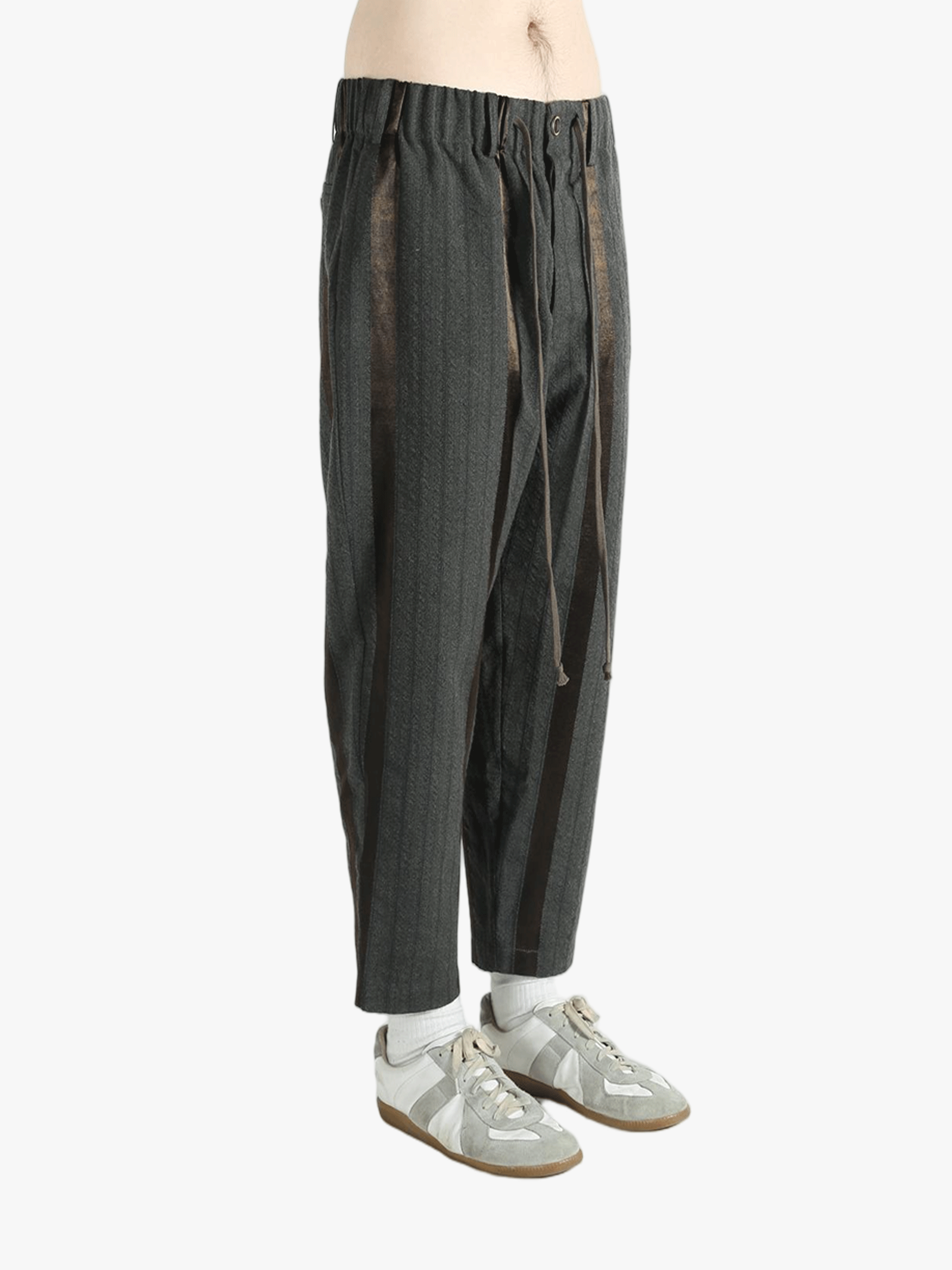 Grey pants worn by a person, showing the pants' fit