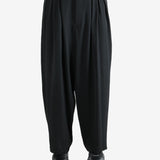 black pants  worn by a person, showing the pants fit