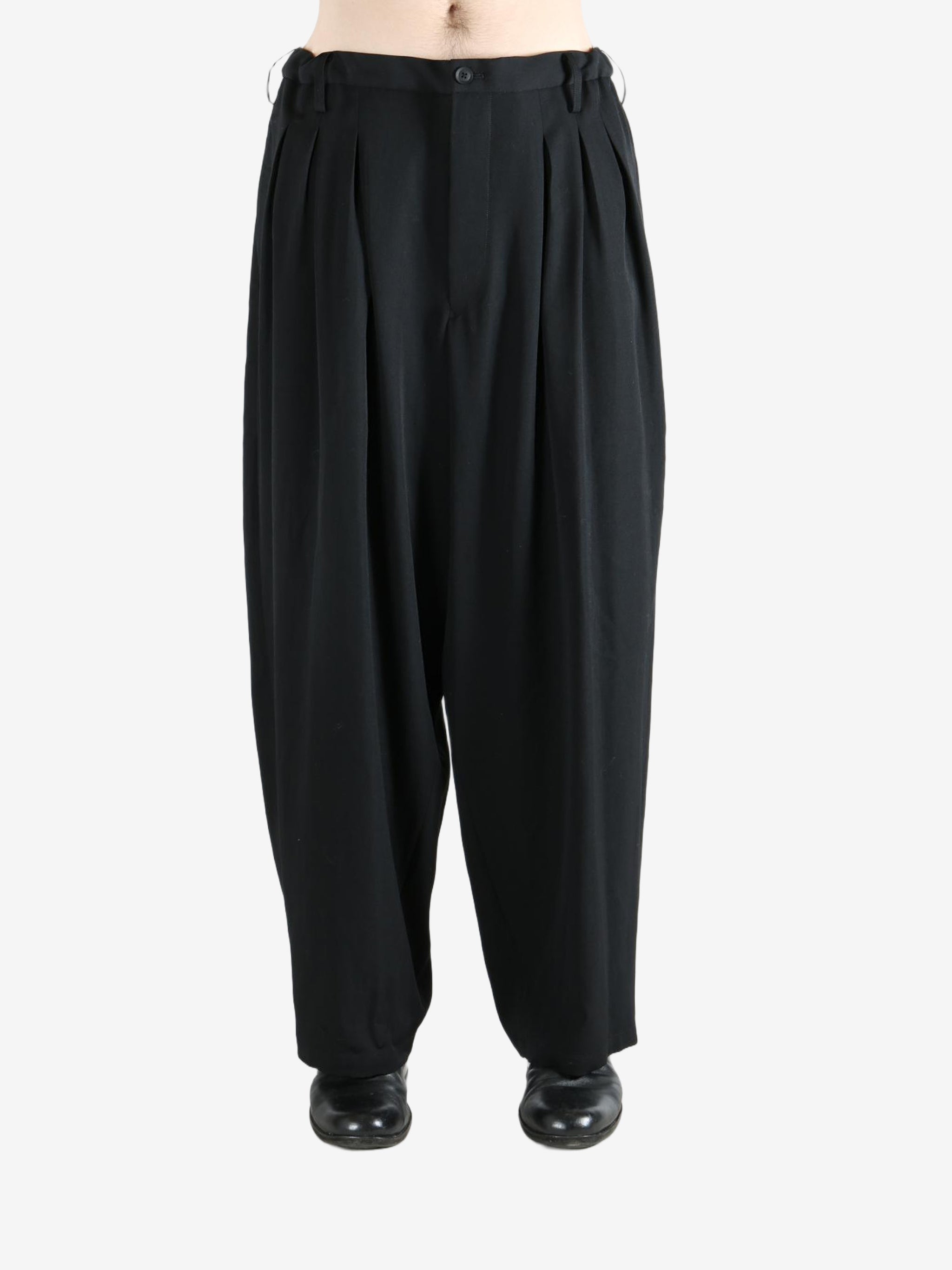 black pants  worn by a person, showing the pants fit