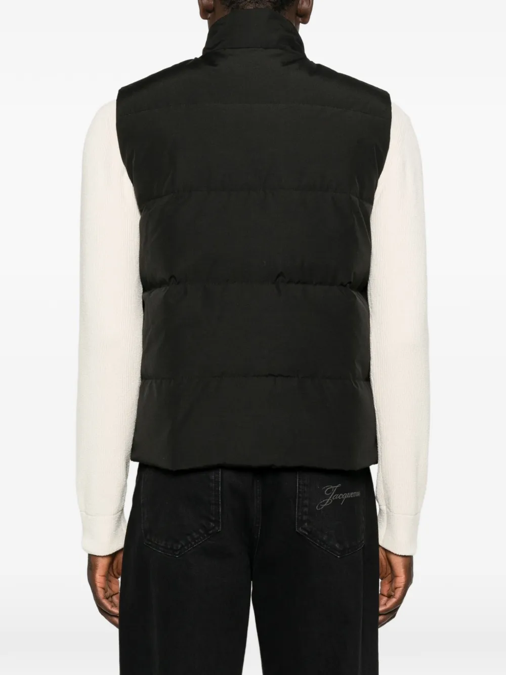 Black jacket worn by a person, showing the jacket fit