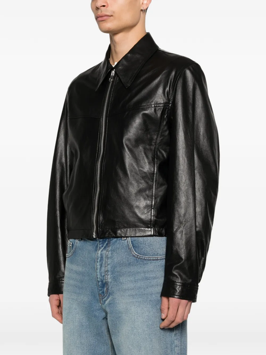 Black leather jacket worn by a person, showing the jacket fit