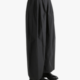 Black pants worn by a person, showing the pants fit