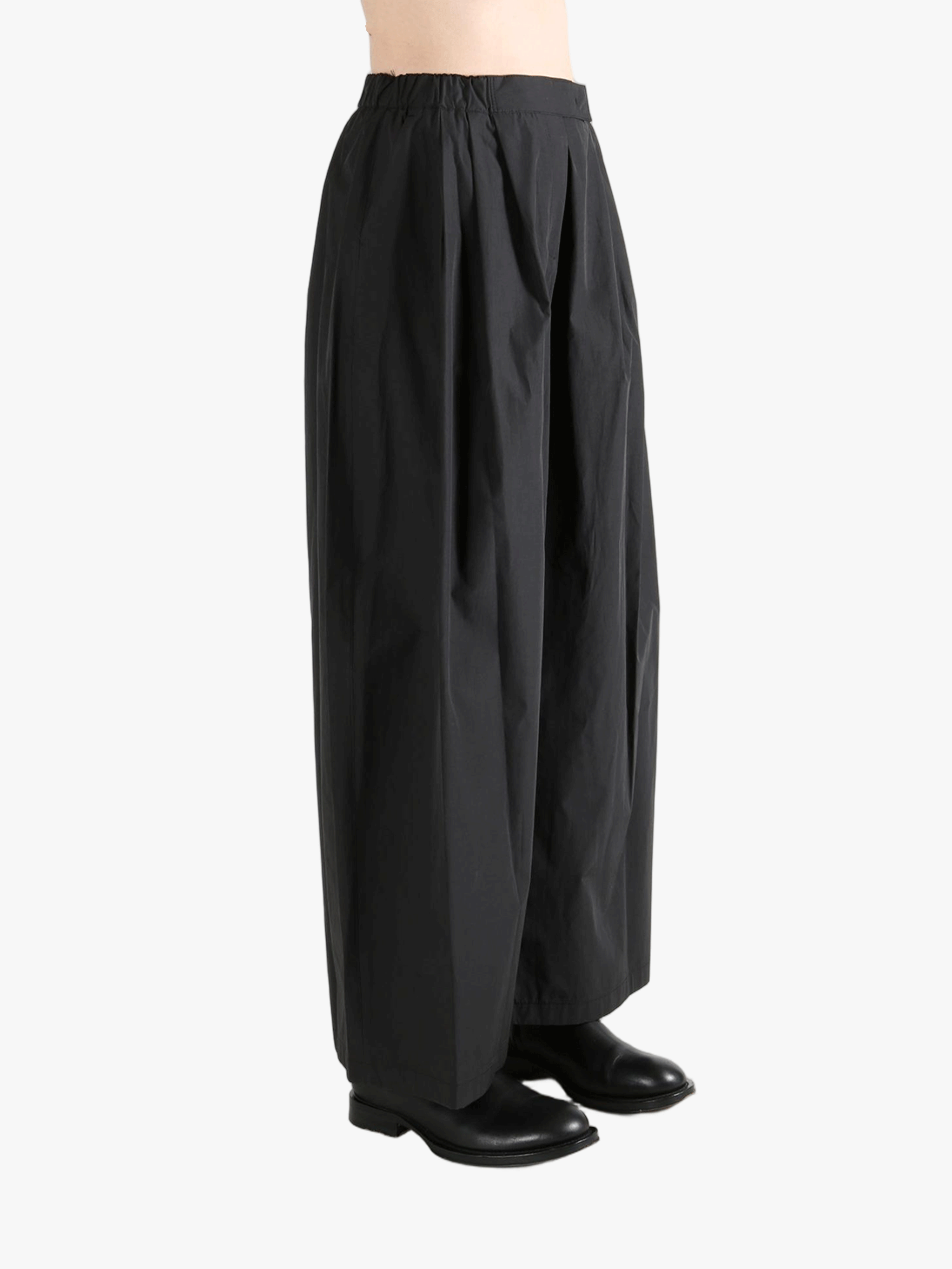 Black pants worn by a person, showing the pants fit