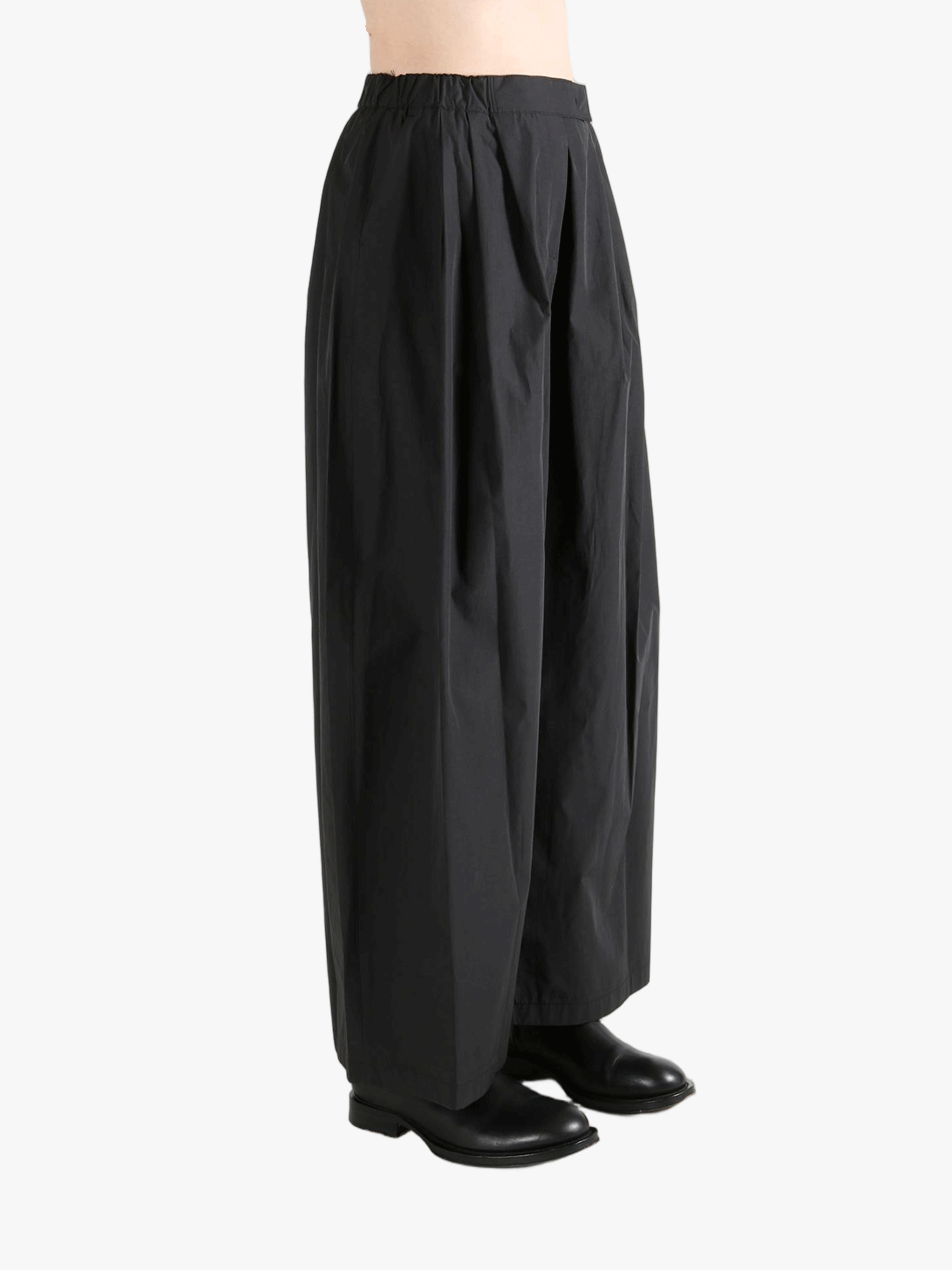 Black pants worn by a person, showing the pants fit