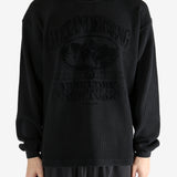 Black t-shirt worn by a person, showing the t-shirt's fit