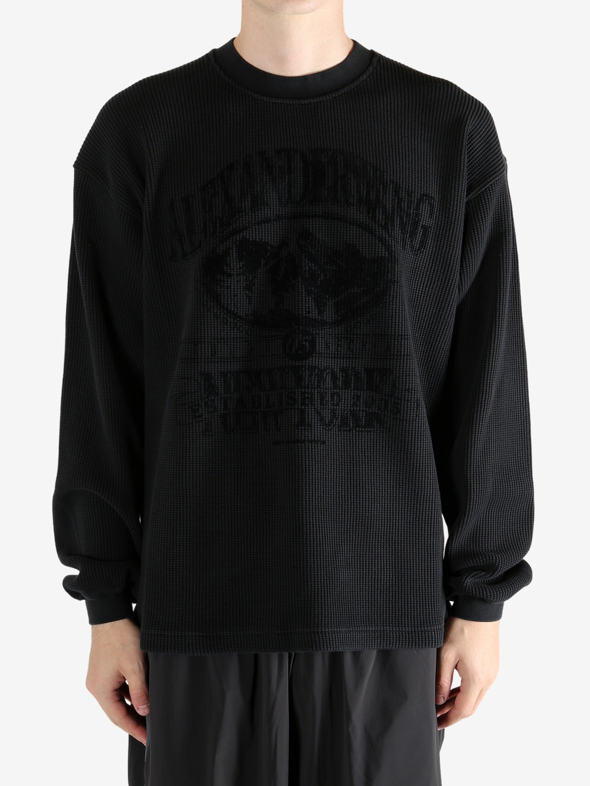 Black t-shirt worn by a person, showing the t-shirt's fit