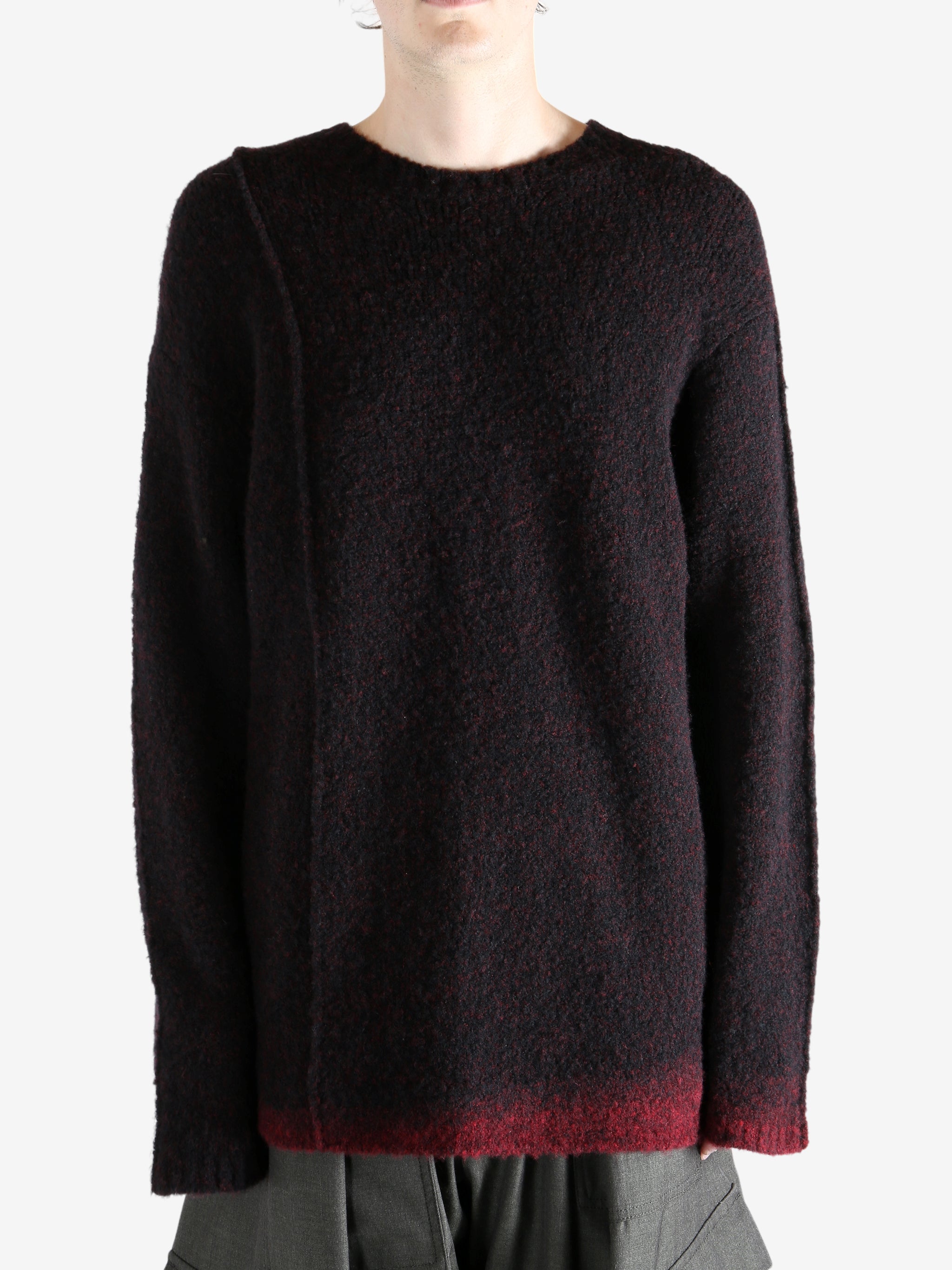 Black knitwear worn by a person, showing the knitwear's fit