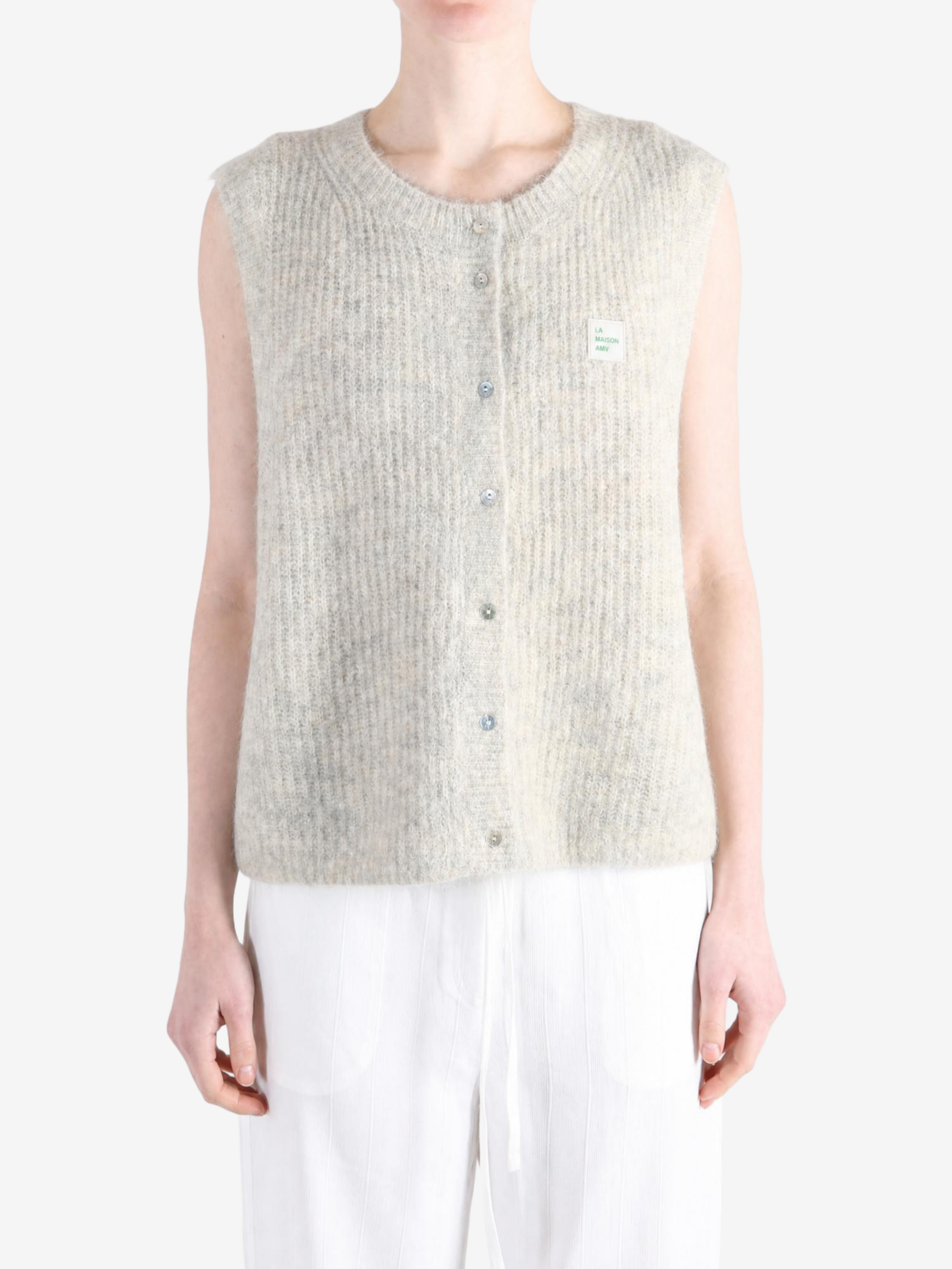 Tan knitwear worn by a person, showing the knitwear fit