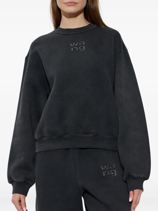 Black sweatshirt worn by a person, showing the sweatshirt fit