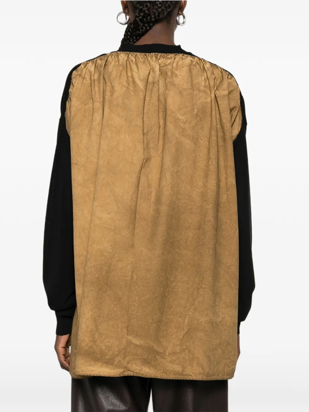 Black knitwear worn by a person, showing the knitwear fit