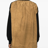 Black knitwear worn by a person, showing the knitwear fit