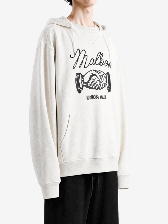 Tan hoodie worn by a person, showing the hoodie fit