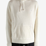 White knitwear worn by a person, showing the knitwear's fit